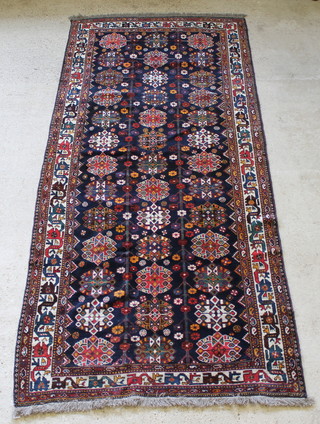A Luri  blue and white ground carpet with numerous medallions to the centre 143" x 63" 
