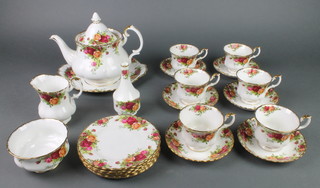 A 23 piece Royal Albert Old Country Rose pattern tea service comprising teapot, sugar bowl, sandwich plate, 6 cups, 6 saucers, 6 tea plates and a vase 
