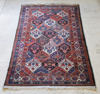 A Bakhtiar  blue and red ground rug, in wear. 120" x 79" 
