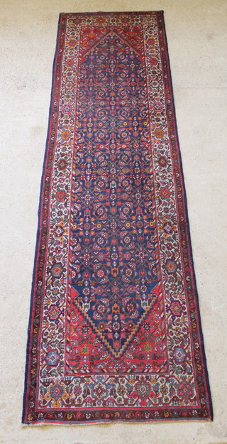 A Malayer red and blue ground runner with diamond medallion to the centre 159" x 41" 
