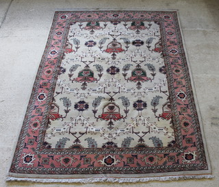 A Tabriz white and pink ground carpet, some staining,  119" x 85" 
