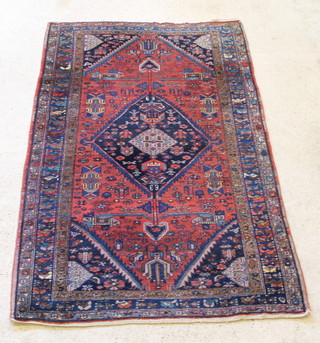 A Persian Tfrersher red and blue ground rug with central medallion 78" x 51" 
 