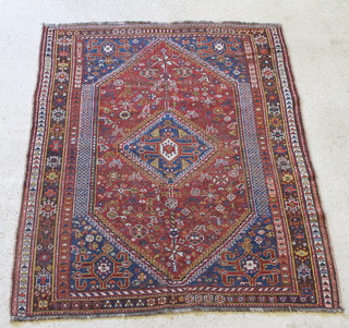A Persian Qashqai brown and blue ground rug, in wear 73" x 57" 

