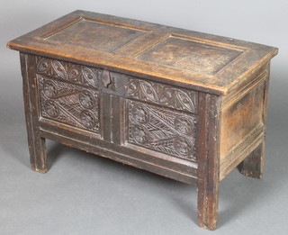 A 17th/18th Century carved oak coffer of panelled construction, with iron hinges and lock, the interior fitted a candle box, 22" 1/2"h x 37"w x 18"d 
