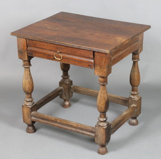 An 18th Century oak side table fitted a frieze drawer with brass loop handle, raised on turned and block supports with box framed stretcher 27"h x 26"w x 21 1/2"d 