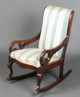 A child's Victorian mahogany show frame rocking chair upholstered in blue and white striped material 
