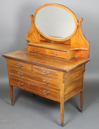 An Edwardian inlaid mahogany dressing chest with oval plate mirror, the base fitted 2 glove drawers, 2 short and 2 long drawers, raised on square tapered supports 56"h x 42"w x 19 1/2"d 