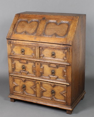 An 'Ipswich' Jacobean style oak bureau, the fall front revealing a well fitted interior with cupboard, pigeon holes and drawers above 2 short and 2 long drawers, raised on bracket feet with geometric mouldings 29"h x 30"w x 18"d 