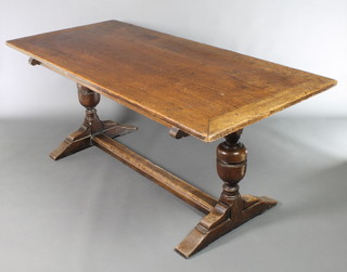 An oak refectory dining table raised on cup and cover supports with H Framed stretcher 30"h x 72"l x 33 1/2"w 