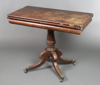 A Georgian rosewood card table of rectangular form, raised on a turned column and tripod base ending in brass caps and castors 29 1/2"h x 36"w x 18"d 