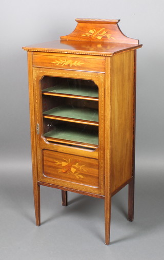 An Edwardian inlaid mahogany music cabinet with raised back, fitted shelves enclosed by glazed panelled doors, raised on square supports 45 1/2"h x 20"w x 14"d 