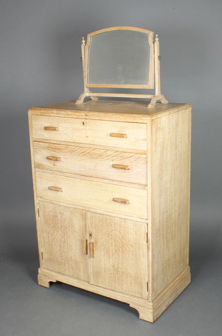 A 1930's Art Deco Heals style limed oak chest, with arch shaped plate mirror to the top contained in a swing frame, fitted 3 long drawers above a double cupboard enclosed by panelled doors, raised on a platform base 58"h x 29 1/2"w x 18"d 