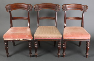 A set of 3 Regency mahogany carved bar back dining chairs with over stuffed seats, raised on ring turned supports