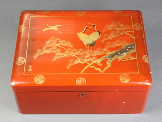 A rectangular japanese red lacquered trinket box, the lid decorated storks and signed to the bottom left hand edge 5"h x 12"w x 9"d 