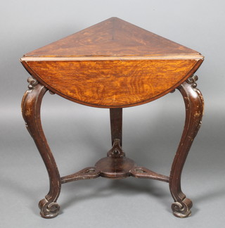 A Victorian oak triangular drop flap table, circular when opened,  the base fitted a drawer, raised on 3 carved cabriole supports with pierced and shaped undertier 27"h x 24" x 32" diam when open