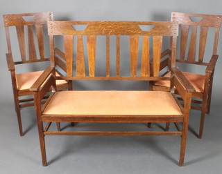 An Art Nouveau oak double chair back settee, raised on square tapering supports together 2 matching armchairs 