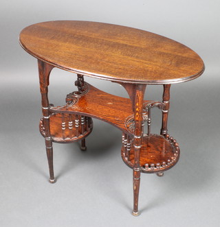 An oak oval Art Nouveau occasional table with carved undertier and 2 circular platforms beneath, raised on turned supports 29"h x 33"w x 18"d 