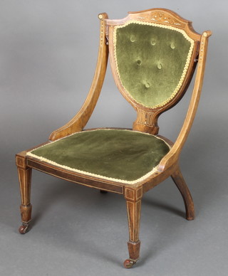An Edwardian inlaid rosewood shield back nursing chair with upholstered seat and back, raised on square tapered supports