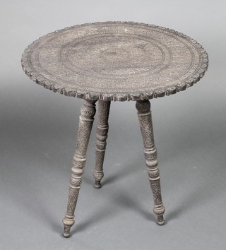 A 19th Century circular carved Indian occasional table, raised on 3 turned supports 22"h x 21" diam. 
