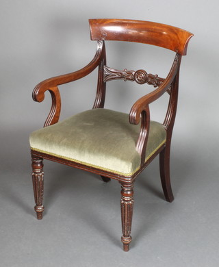 A Georgian mahogany bar back carver chair with carved mid rail and upholstered seat, raised on turned and fluted supports 