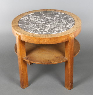 An Art Deco circular oak 2 tier occasional table, the top inset a black veined marble panel 21"h x 23" diam. 