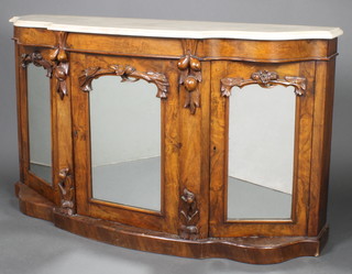 A Victorian walnut sideboard of serpentine outline with white veined marble top enclosed by 3 arched mirror panelled doors 33 1/2"h x 58 1/2"w x 16 1/2"d  