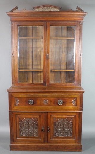 A Victorian carved walnut secretaire bookcase, the upper section with carved and moulded cornice the interior fitted adjustable shelves enclosed by bevelled glazed panelled doors, the base fitted a secretaire drawer above double cupboard enclosed by panelled doors 97"h x 47"w x 22"d 