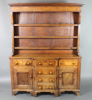 An 18th Century oak dresser, the raised back with moulded cornice fitted 3 shelves above 4 long drawers, flanked by 2 long drawers above a double cupboard and with turned column to the sides 83"h x 63"w x 18"d 