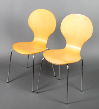 A pair of 1960's style shaped plywood and chrome stacking chairs 