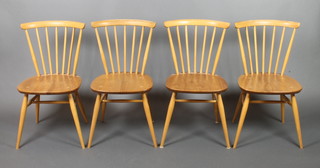 A set of 4 Ercol light elm stick and rail back dining chairs with H framed stretchers, raised on turned supports, the base marked B.S.J.F. 1960 2056 