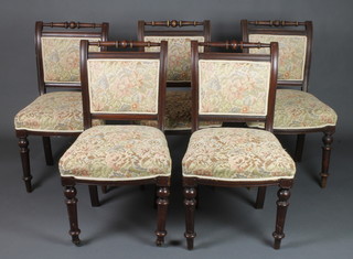 A set of 5 Edwardian mahogany dining chairs with upholstered seats and backs, raised on turned supports 