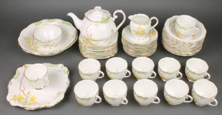 A Roslyn China Spring Time tea set comprising 12 tea cups, 12 saucers, teapot, milk jug and sugar bowl, 12 small plates, 2 sandwich plates, 2 salad bowls, 12 dessert bowls