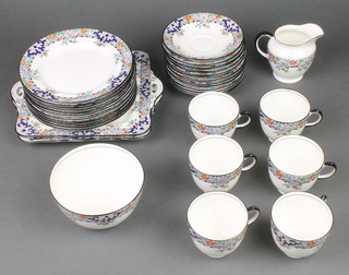 A Delphine china teaset comprising 6 tea cups, 12 saucers, 12 small plates, milk jug, sugar bowl and 2 serving plates 