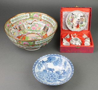 A modern famille rose punch bowl decorated with figures 12", a Japanese bowl decorated flowers 8" and a modern cased Chinese miniature tea set 