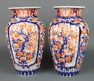 A pair of late 19th Century Imari fluted oviform vases decorated with panels of flowers and trees 12 1/2" 