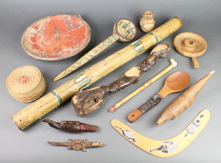 An Australian rain stick, a boomerang and other carved wooden items 
