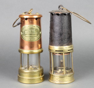 An authentic brass and iron miner's safety lamp together with a copper and brass miner's safety lamp 