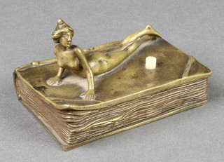 An Art Nouveau bronze servants bell push in the form of a rectangular book, the top decorated a figure of a recumbent lady 4" 