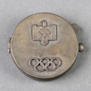 A circular rouge pot/compact, the lid decorated a German eagle and Olympic rings, the interior set a later compass 