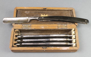 4 Clements cut throat razors, Sunday, Monday, Tuesday and Wednesday, contained in an oak box
