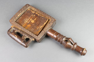 A Nigerian rectangular carved wooden "cosmetic" box with sliding panel and turned handle inset a ball 16"