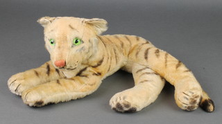 A Steiff style figure of a seated tiger with green glass eyes 15", some wear to body and whiskers are missing