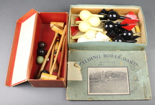 An Alliance Series table croquet game comprising 4 mallets, 5 balls and 2 skittles, a folding Spalding Bowle's Darts comprising 4 black darts and 5 white darts boxed (box damaged)
