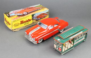 A Mechanical and Auto Minster Deluxe model car boxed, together with a tin plate model of a tram