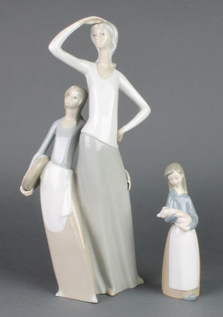 A Spanish group of a lady with young girl 14" and a Lladro figure of a girl holding a piglet 1011 7" 