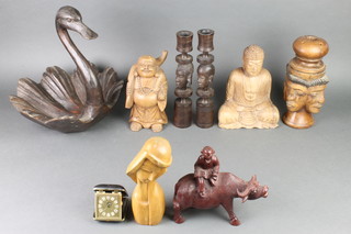 A carved wooden dish in the form of a swan 15", a pair of African carved wooden candlesticks decorated portrait busts 11" and other carved wooden figures