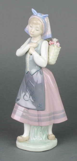 A Lladro figure of a girl holding a basket of flowers on her back 10 1/2", boxed