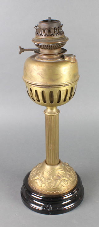 An Art Nouveau embossed brass oil lamp stand with associated reservoir (dent to reservoir) 