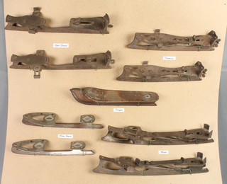 4 pairs of 19th Century steel ice skates and 1 other single ice skate mounted on a plywood board 