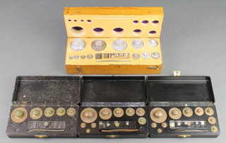 A set of chemists weights contained in a mahogany box together with 3 sets of Philip Harris weights 